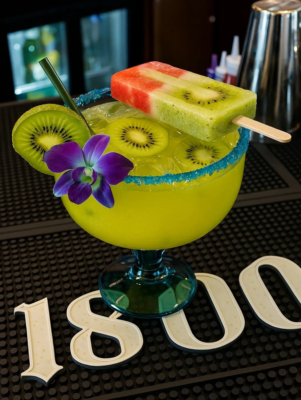 A kiwi margarita with an orchid